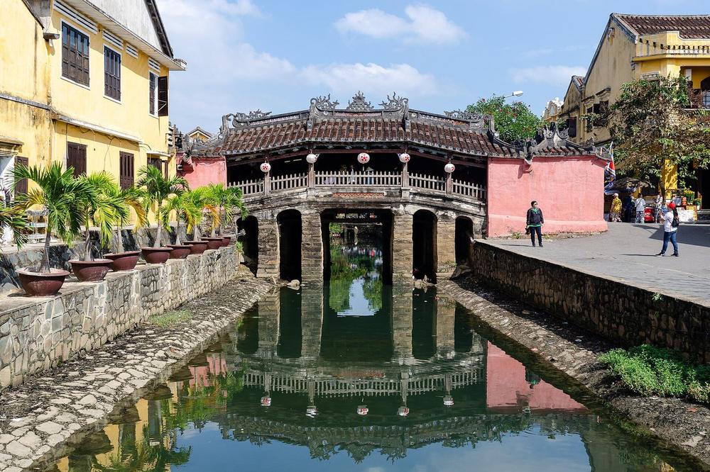 A covered bridge over a narrow canal at the end of an old street A covered bridge over a narrow canal at the end of an old street