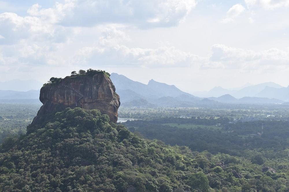 The flat-topped rock of Sigiriya standing out of surrounding scrub The flat-topped rock of Sigiriya standing out of surrounding scrub